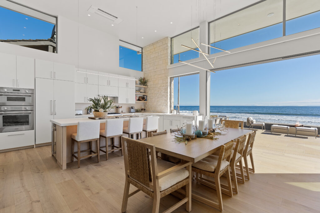 A large dining room with a view of the ocean.