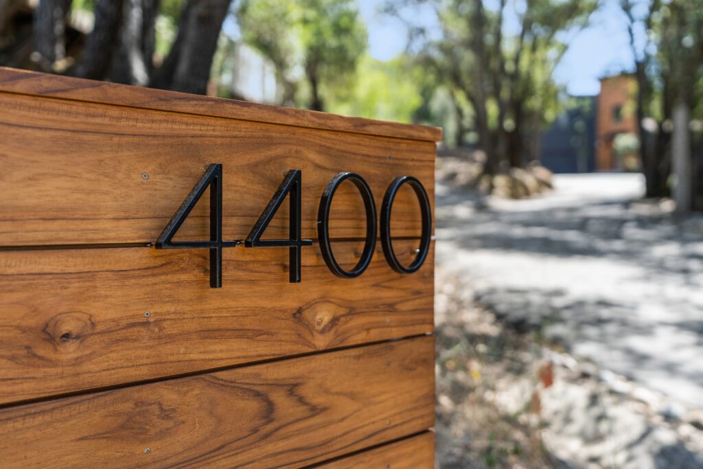 A close up of the number 4 4 0 0 on a wooden sign